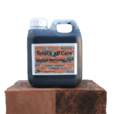 1L jerry can of Total Wall Care Soot Wash standing on half treated brick