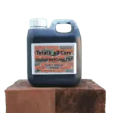 1L jerry can of Total Wall Care Soot Wash standing on half treated brick