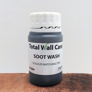 75ml Sample pot of Total Wall Care Soot Wash Brick Dye standing on part tretaed brick.