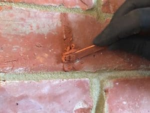 Picture showing cracked brick being repaired with crack repair injection mortar