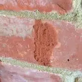 Picture showing cracked brick being repaired with crack repair injection mortar