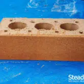 Buff brick with first coat of burnt orange brick tint