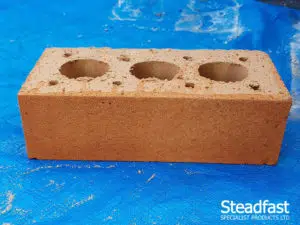 Buff brick with first coat of burnt orange brick tint