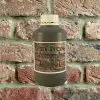 Bottle of Khaki Mortar Tint against brick wall
