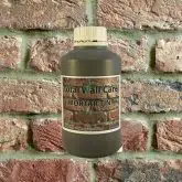 Bottle of Khaki Mortar Tint against brick wall