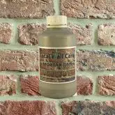 Bottle of Light Khaki Mortar Tint against brick wall
