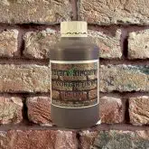 Bottle of Plum Mortar Tint against brick wall