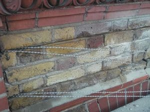 Reinforcing brick lintel with helical bar